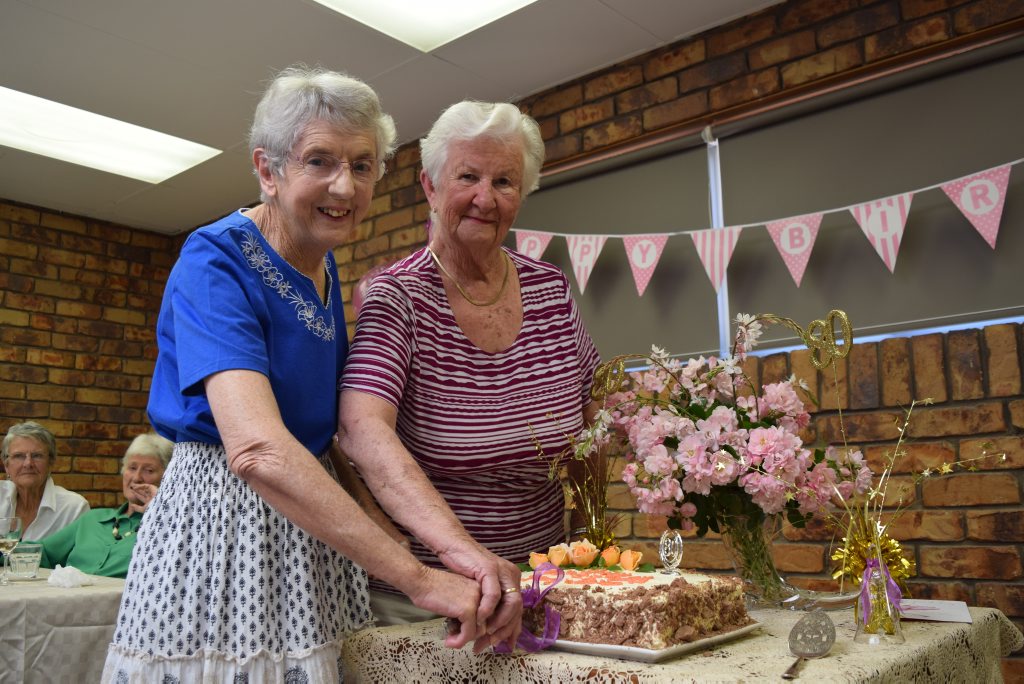 REASON TO CELEBRATE: Joan Lindenberg and Daree Foster cut the cake at their 80th birthday party at Cafe Jacqui's yesterday.